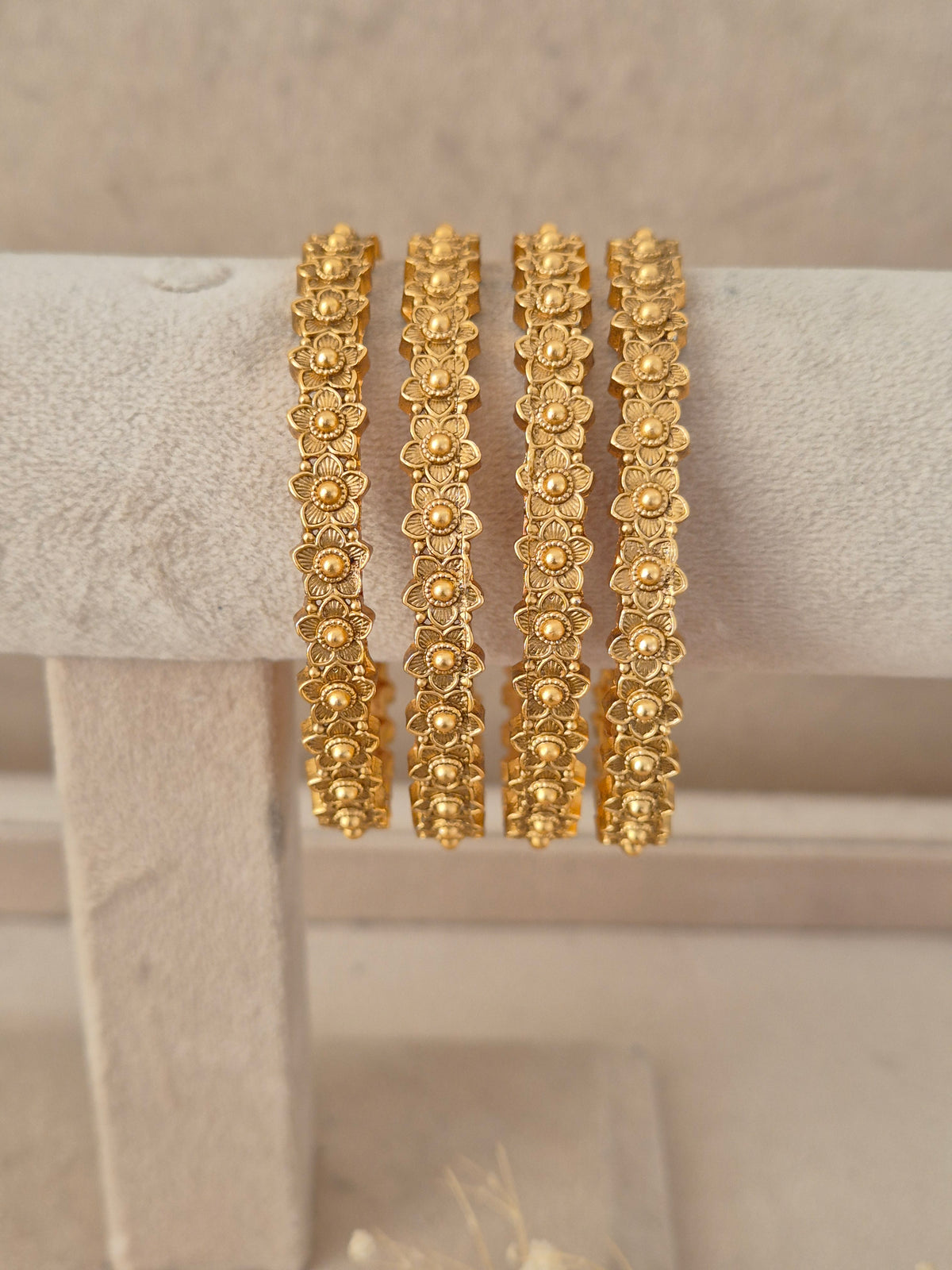 Elegant festive Indian gold-plated bangles with intricate heritage floral detailing, perfect for weddings, Rakhi, and special occasions. by naitri.in