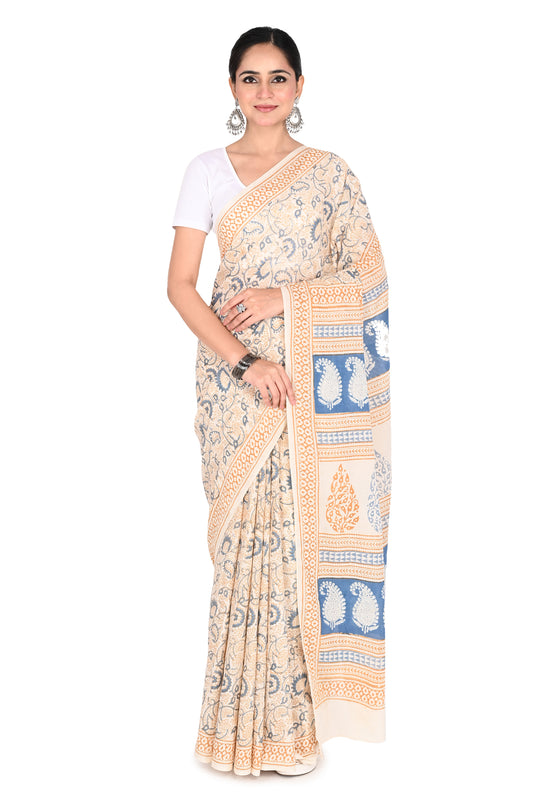 Woman wearing the Padmaja hand block printed cotton saree in white with blue floral motifs and a beige border by naitri.in