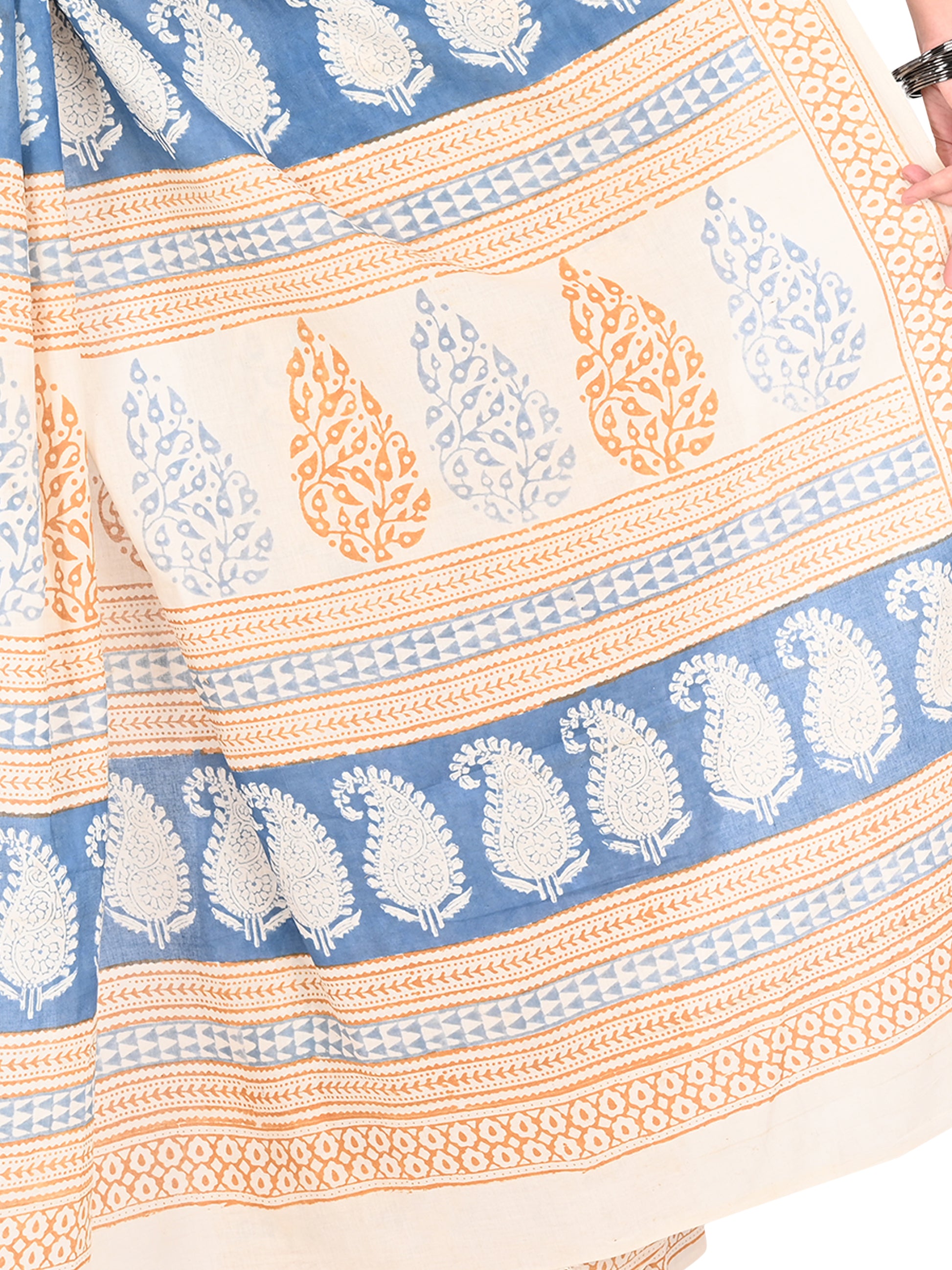 Model showcasing a classic drape of the Padmaja white cotton saree, highlighting the intricate blue floral patterns and earthy beige pallu by naitri.in
