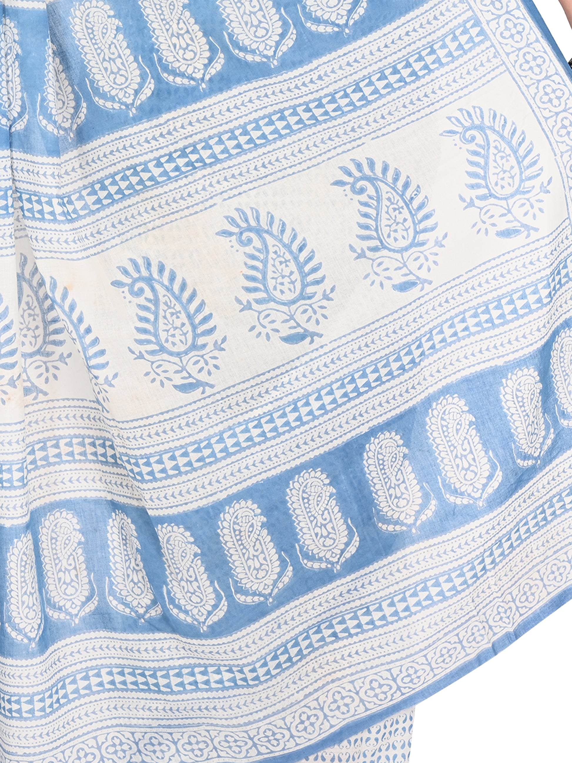 Detailed view of artisanal Bagh hand block printing from Madhya Pradesh on a soft white cotton saree with vibrant blue motifs by naitri.in