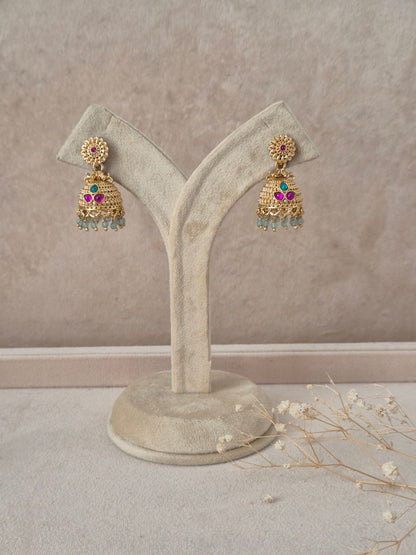 Pankhuri handcrafted gold-finish jhumka earrings with ruby and green stone accents by naitri.in