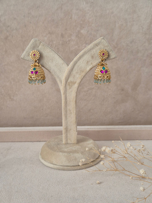 Pankhuri handcrafted gold-finish jhumka earrings with ruby and green stone accents by naitri.in