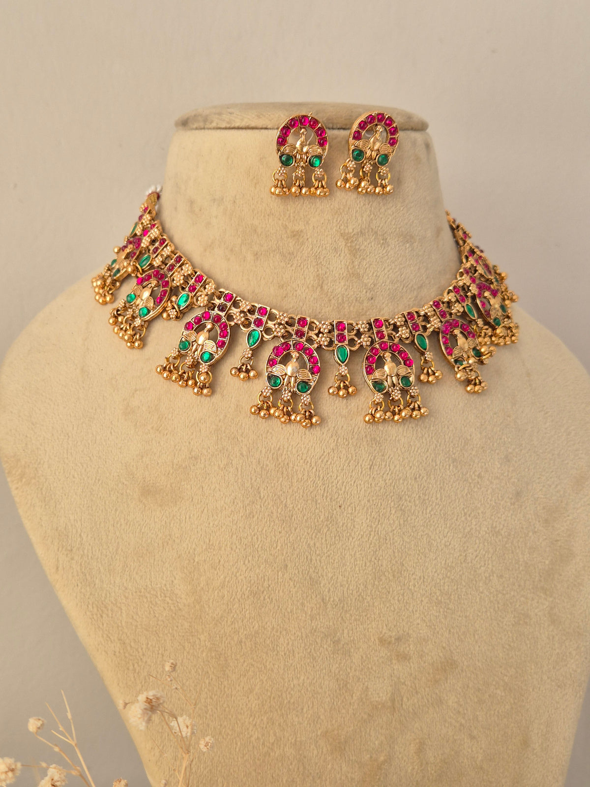 Close-up of a traditional Indian choker necklace set with colorful stones by Naitri.in