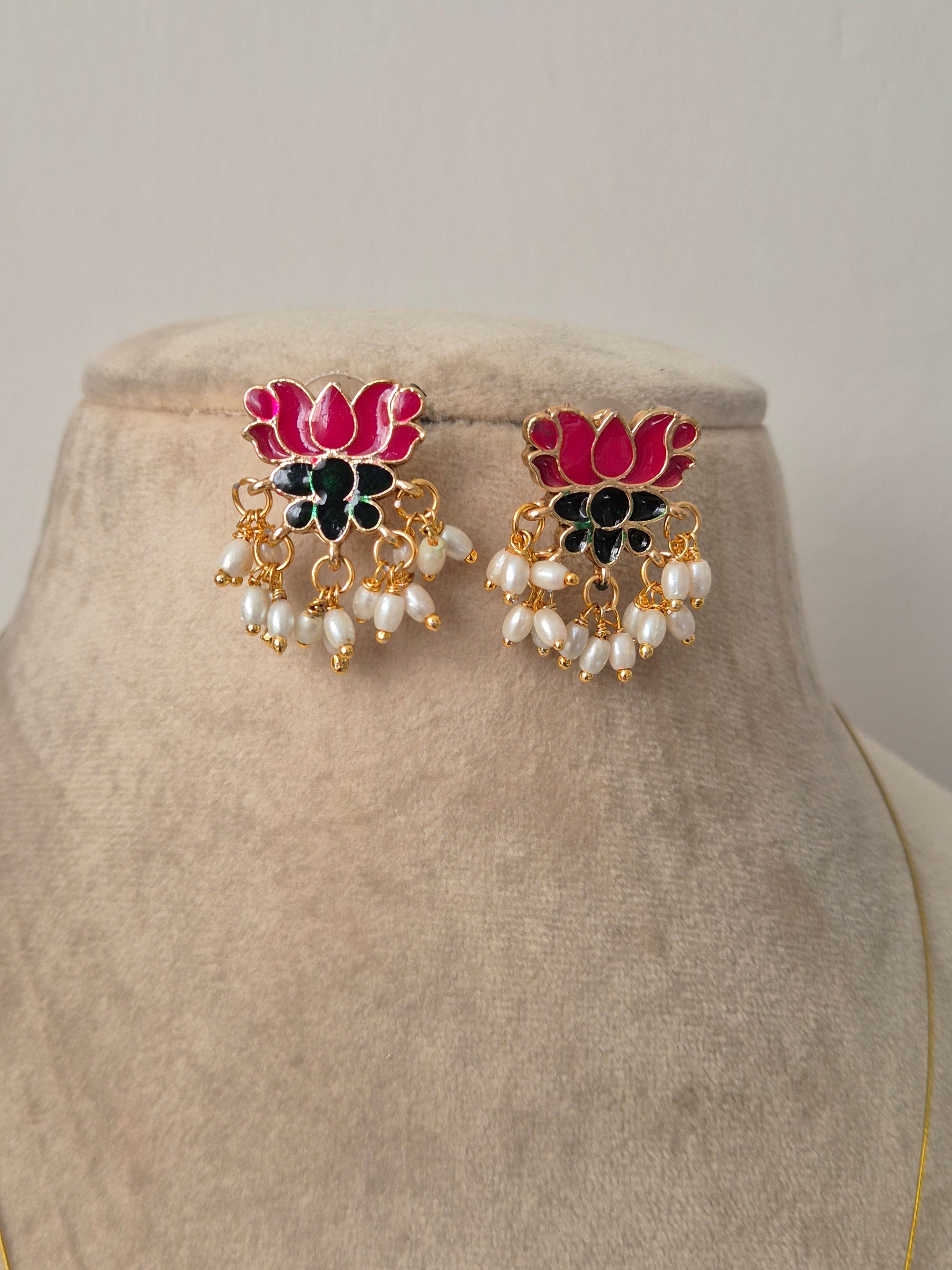 Pair of decorative earrings with pink, green and gold lotus design  and some pearls hanging from flower by naitri.in