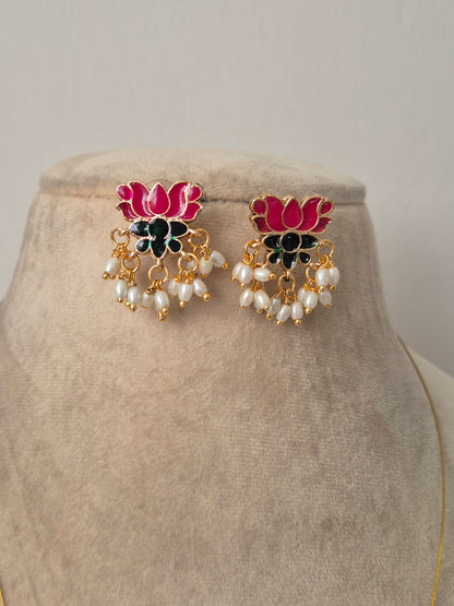 Pair of decorative earrings with pink, green and gold lotus design  and some pearls hanging from flower by naitri.in
