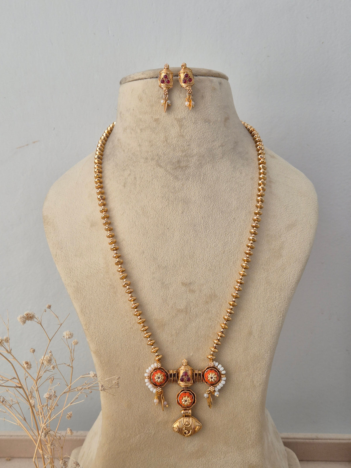 Pavitra Necklace Set featuring a traditional gold mangalsutra-style black beaded chain with an intricate temple pendant and matching earrings by Naitri.in
