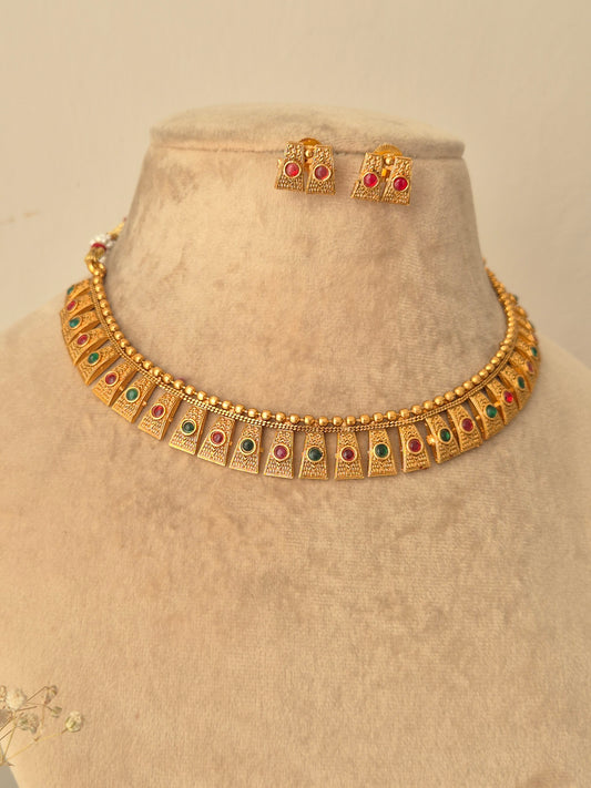 Gold necklace with red-green stones necklace with same designed earring with red stones by naitri.in