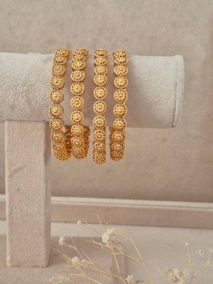 Elegant festive Indian gold-plated bangles with intricate heritage detailing, perfect for weddings, Rakhi, and special occasions. By naitri.in