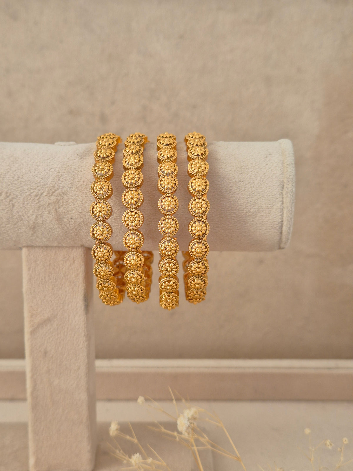 Set of 4 gold-plated Prathna bangles featuring intricate traditional pattern details, neatly arranged  by naitri.in