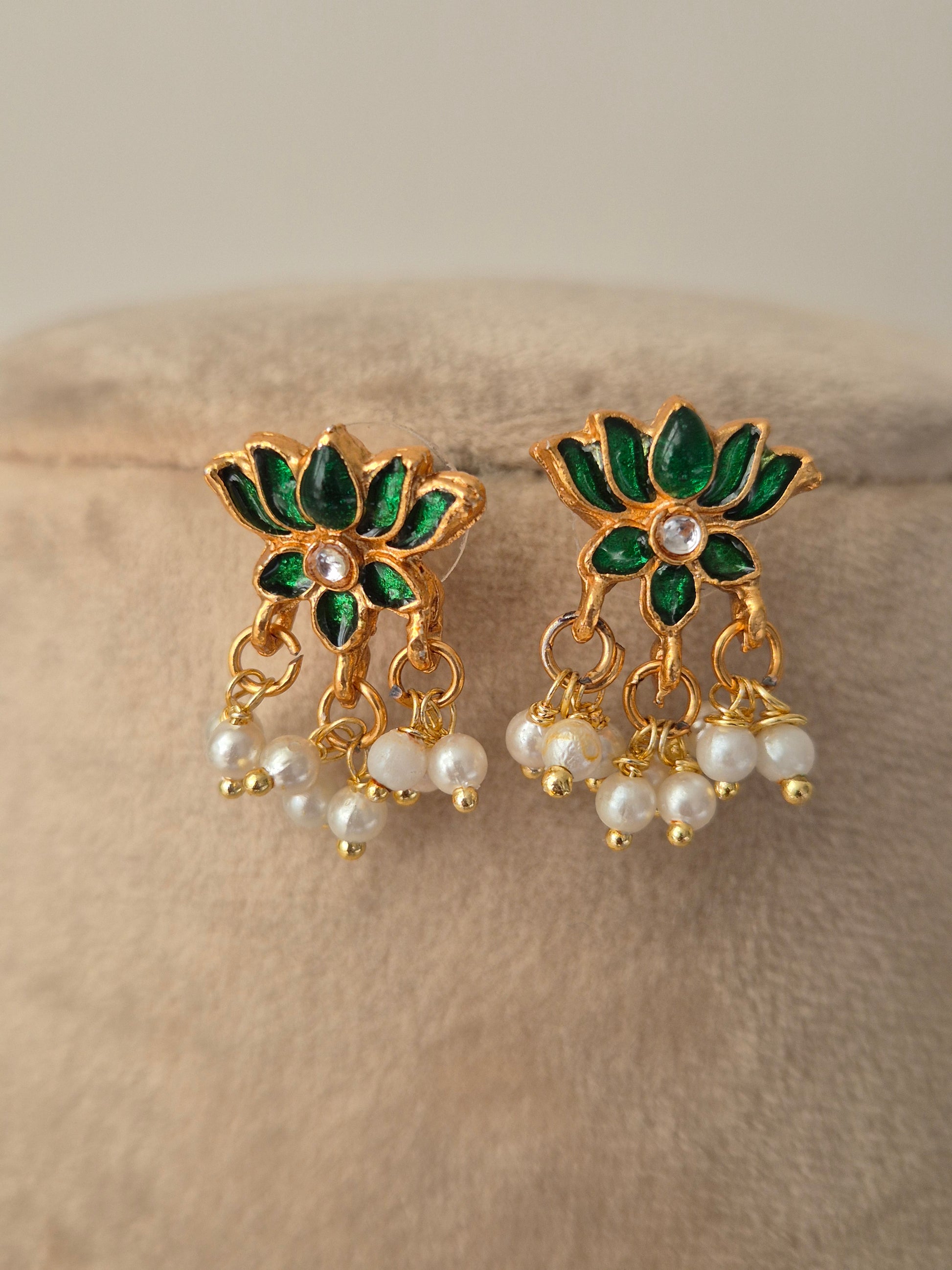 Pair of gold earrings with green leaves and white pearls minimal and aesthetic design by naitri.in 