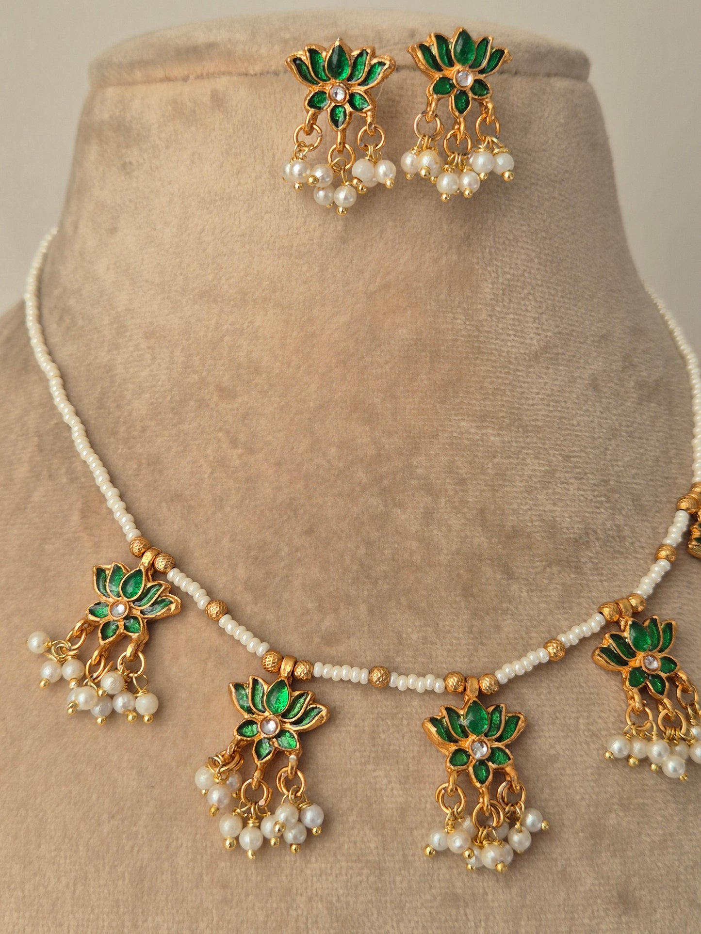 Jewelry set with green and gold elements with Pair of gold earrings with green leaves and white pearls by naitri.in