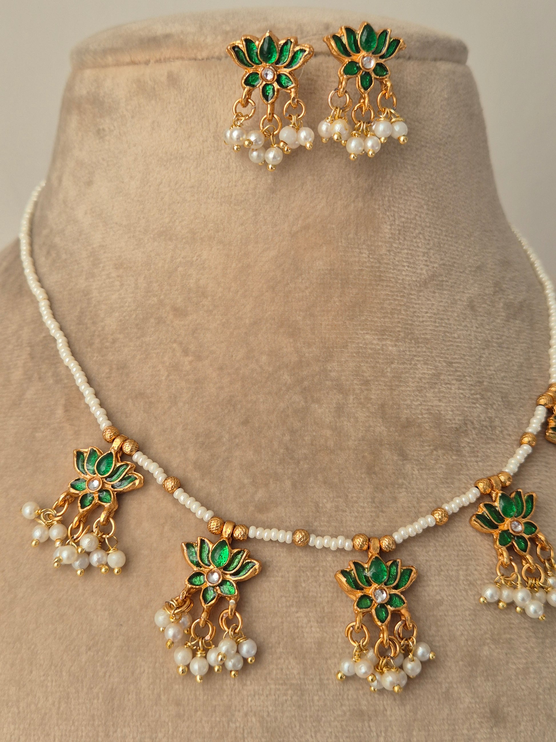 Jewelry set with green and gold elements with Pair of gold earrings with green leaves and white pearls by naitri.in