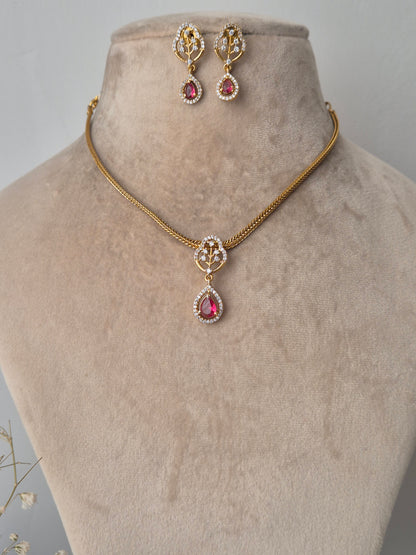 Gold necklace with pink gemstones with earrings minimal design, style everywhere to look stunning by naitri.in