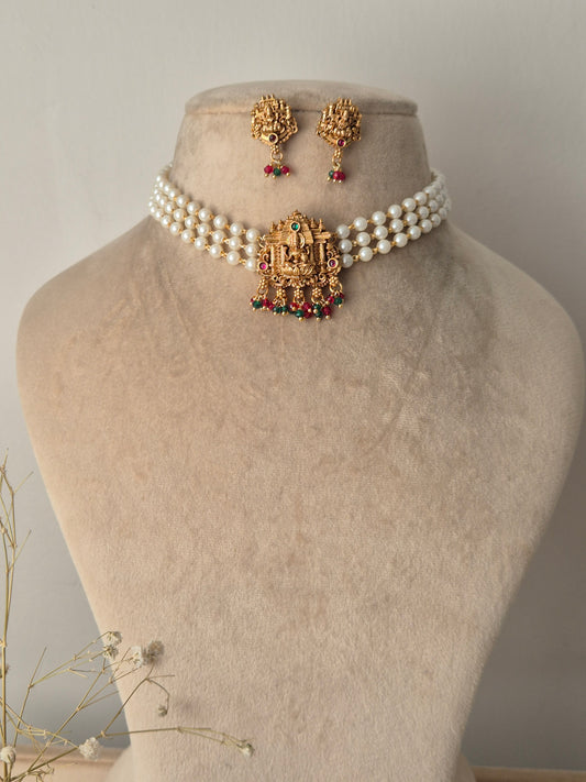 Set of gold jewelry with pearls chain, central motif representing purity and enlightenment, often used as a throne for the goddess by naitri.in