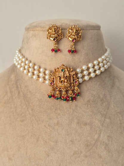 Goddess Lakshmi motif choker set with red and green kemp stones, intricate Nakshi carvings, and matching jhumka earrings by naitri.in