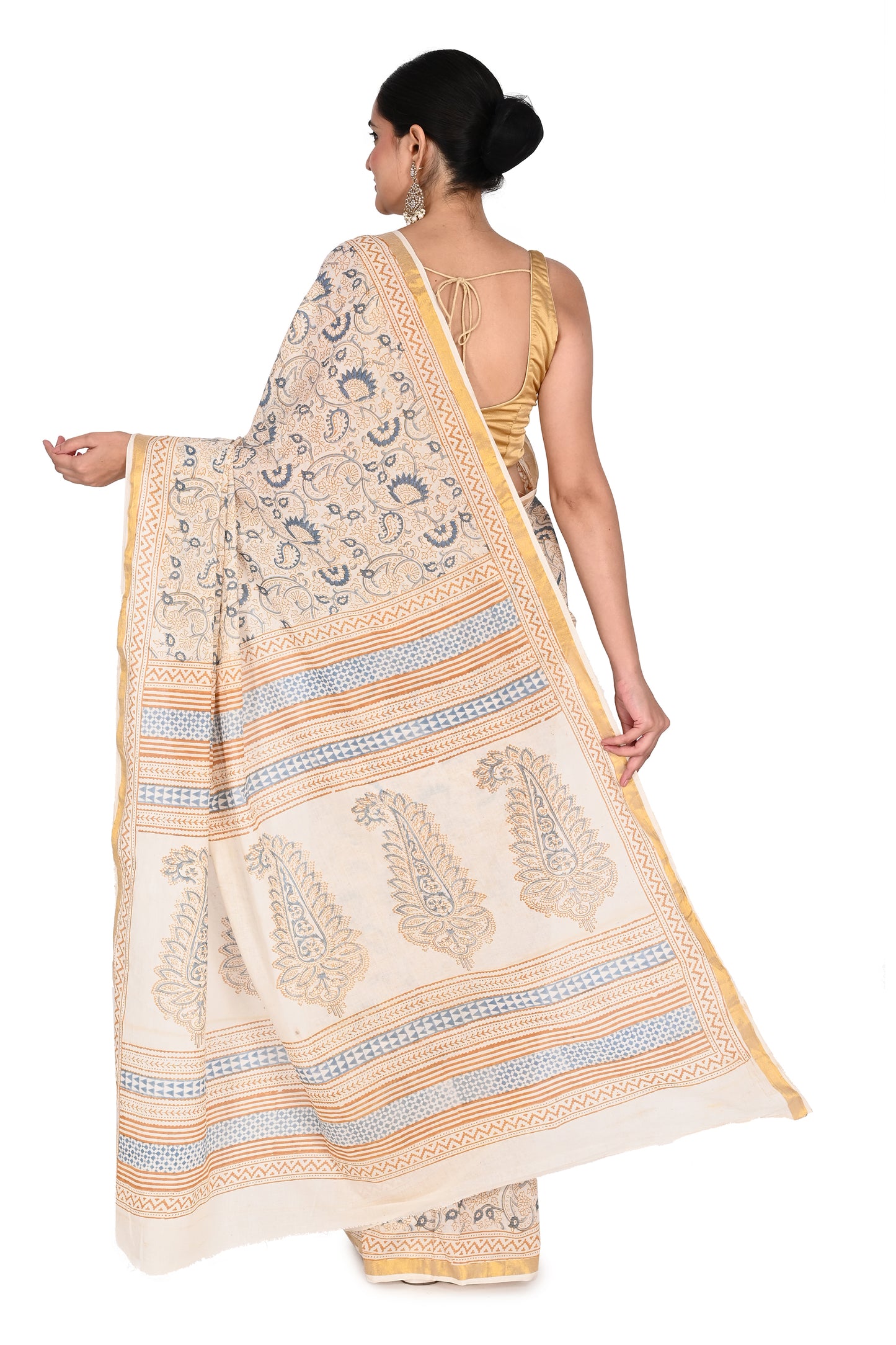 White and blue Punya cotton saree paired with a sleeveless gold blouse and statement earrings, perfect for an elegant casual look by naitri.in