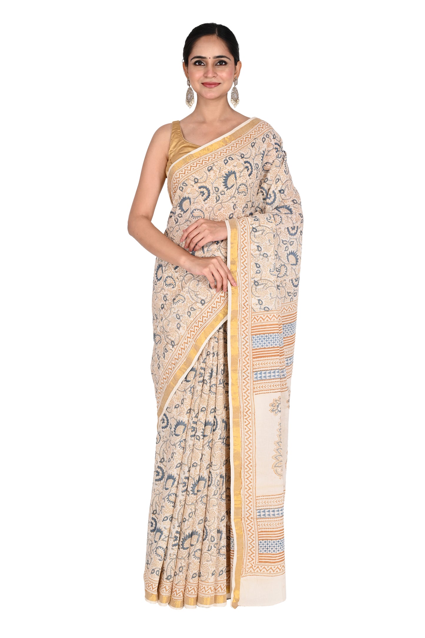 Woman wearing the Punya hand block printed cotton saree in white with blue floral motifs and a beige geometric border by naitri.in