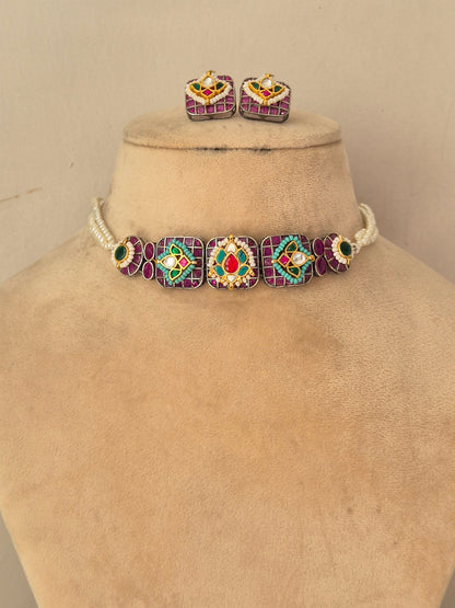 A jewelry set, featuring a choker necklace and matching stud earrings. The necklace has a white beaded base with four large square panels in purple, green, red, and gold, while the matching earrings have a similar multicolor design with a central gold heart by naitri.in