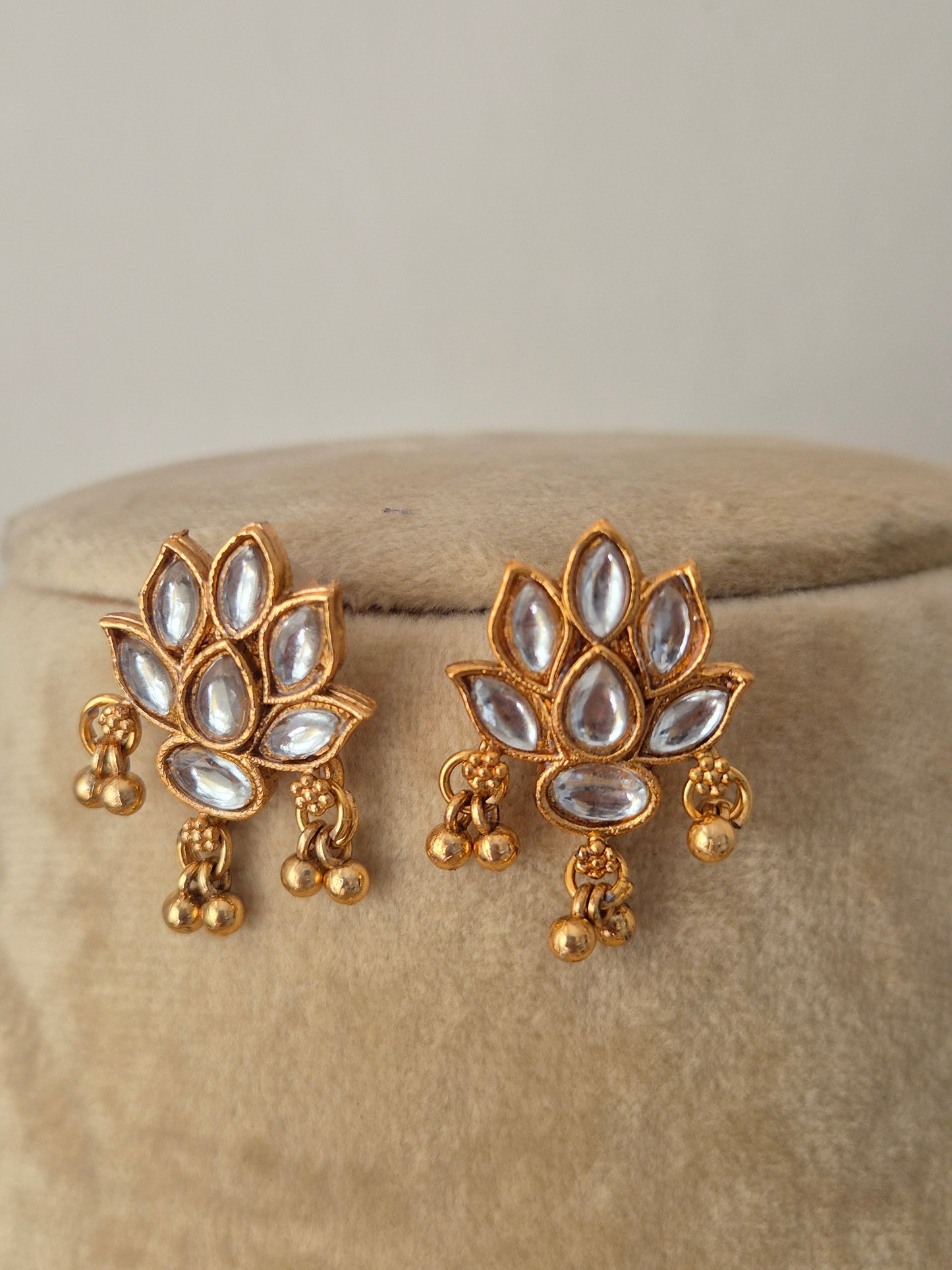 Artisanal Qaynat earring set in a modern Indian ethnic aesthetic, intricate floral carvings, white stone accents, and coordinating festive earrings by naitri.in