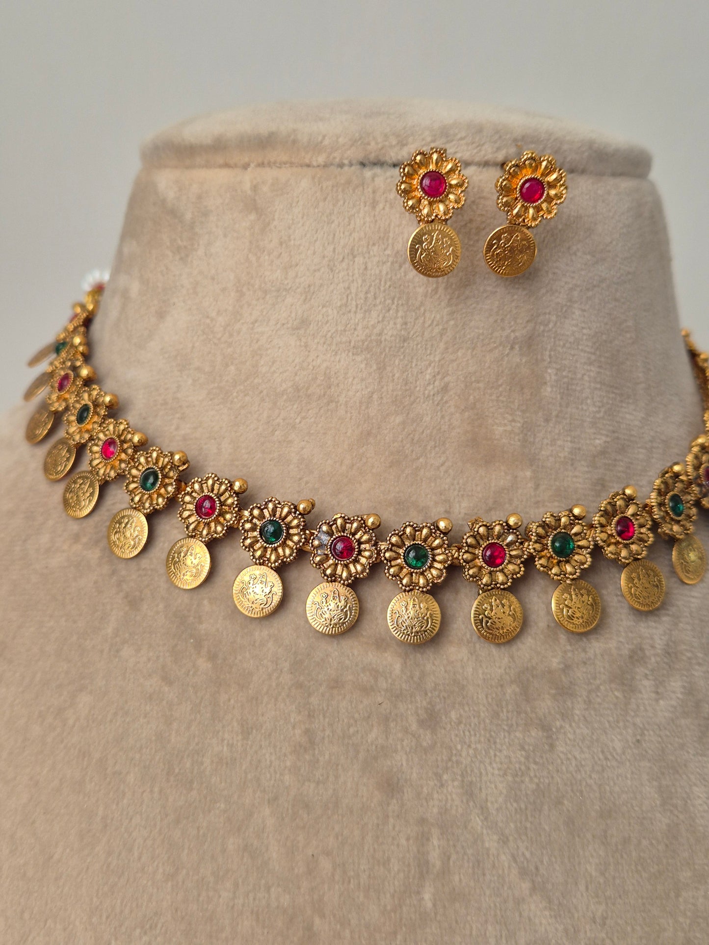 "Handcrafted gold-plated necklace with red-green stones coins drops same designed studded earrings by naitri.in