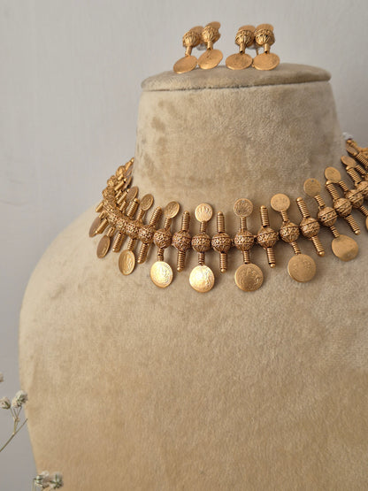 Gold-plated brass choker with a dangling textured coin fringe and coordinating festive earrings from the Naitri collection by naitri.in