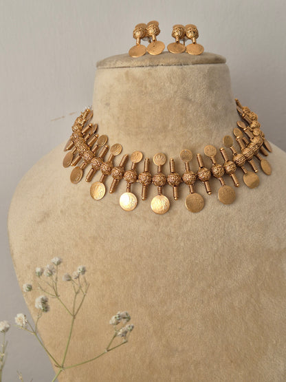 Handcrafted gold choker necklace and matching drop earrings featuring an ethnic coin fringe layout by naitri.in