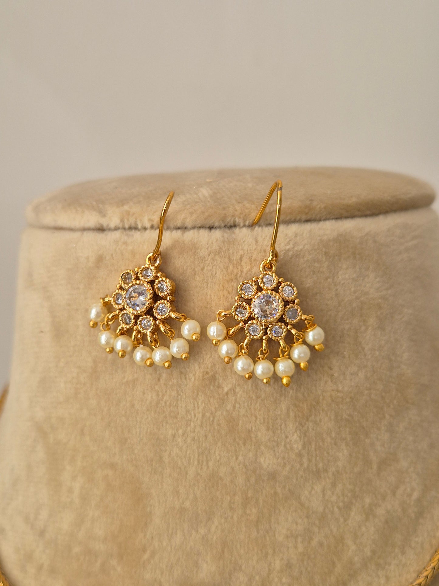 A delicate hanging floral-inspired pendant pearl drop earrings by naitri.in