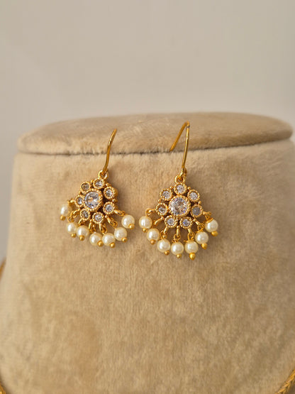 A delicate hanging floral-inspired pendant pearl drop earrings by naitri.in