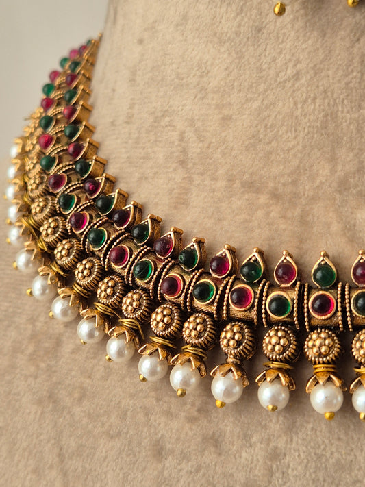 Traditional Indian Raksha necklace and earring set with red and green stones and delicated pearls attached  flora design by naitri.in