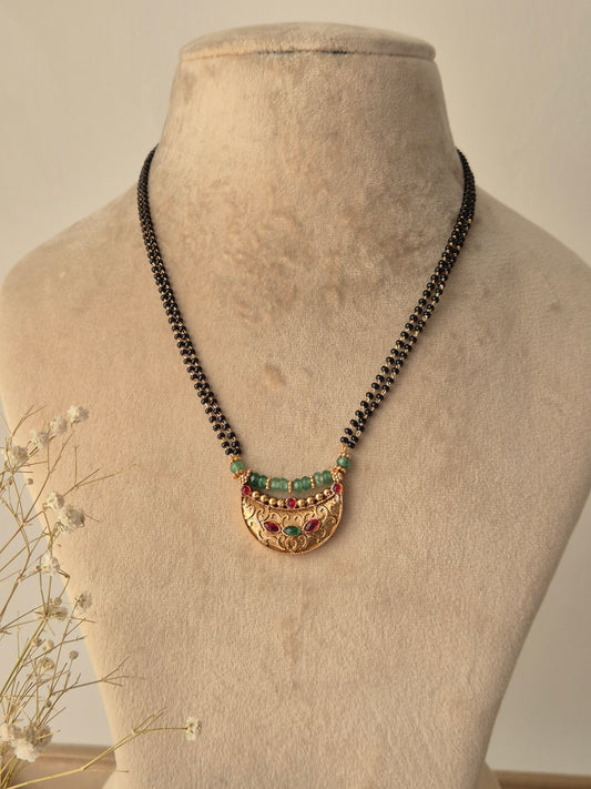 Necklace with green-red gemstones, More than just gold and black beads, it’s a string of our shared dreams and endless love by naitri.in