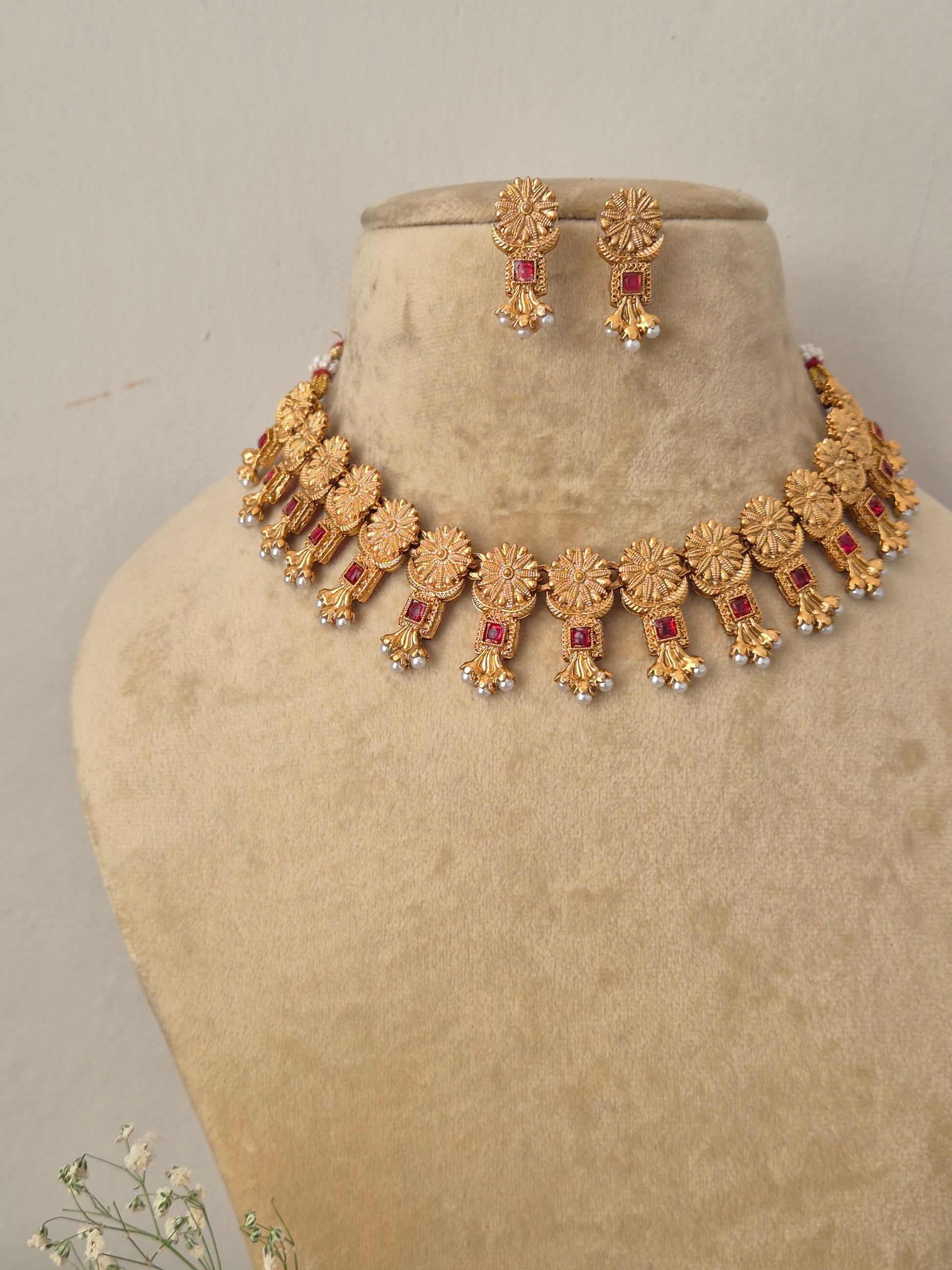 Ornate hand-crafted antique gold statement necklace and earring set, Traditional Indian style golden brass alloy choker necklace and earrings set from the NAITRI jewellery collection by naitri.in 