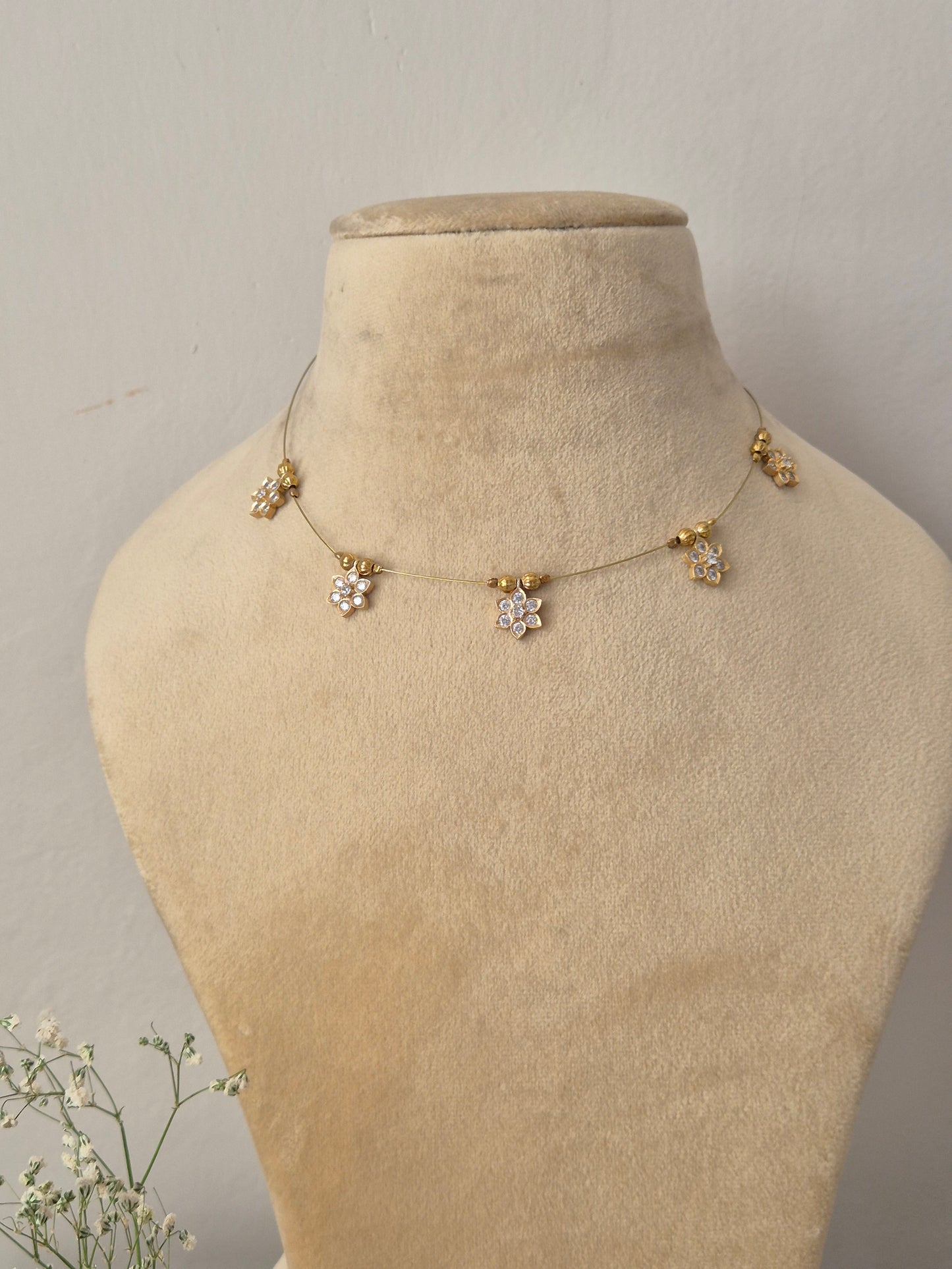 Delicate gold invisible chain necklace featuring minimalist hanging geometric charms by naitri.in