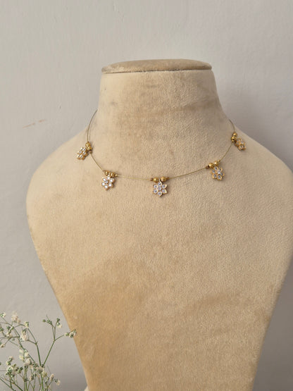 Delicate gold invisible chain necklace featuring minimalist hanging geometric charms by naitri.in