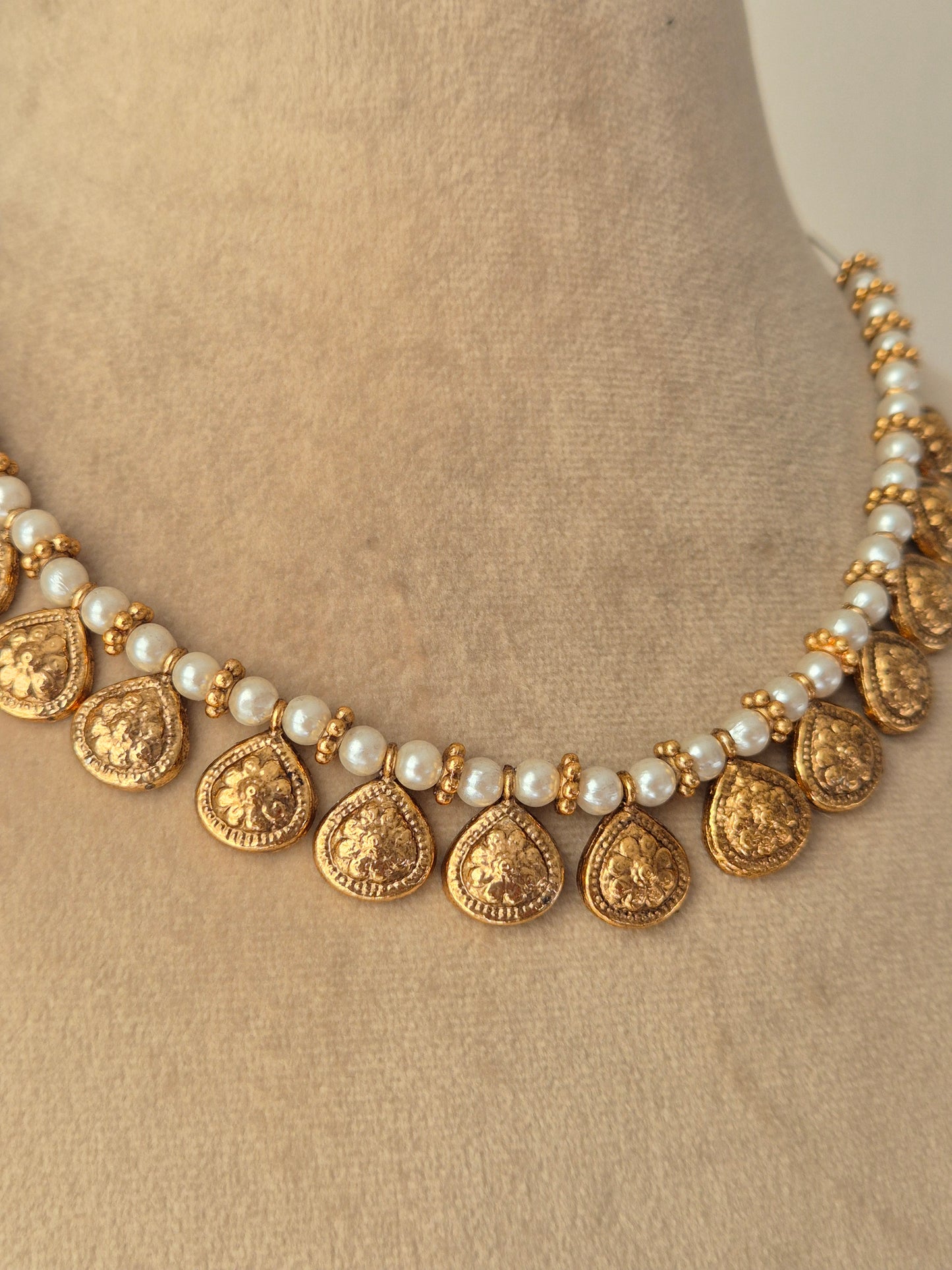 Handcrafted Reet gold-tone choker with pearls and golden-rings and dangling metallic coins by naitri.in