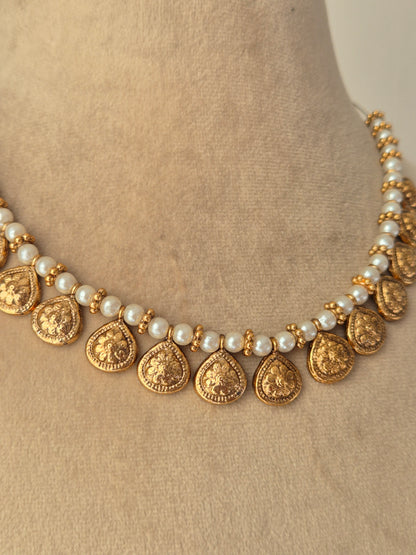 Handcrafted Reet gold-tone choker with pearls and golden-rings and dangling metallic coins by naitri.in