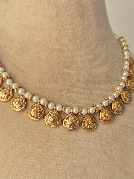 Handcrafted Reet gold-tone choker with pearls and golden-rings and dangling metallic coins by naitri.in