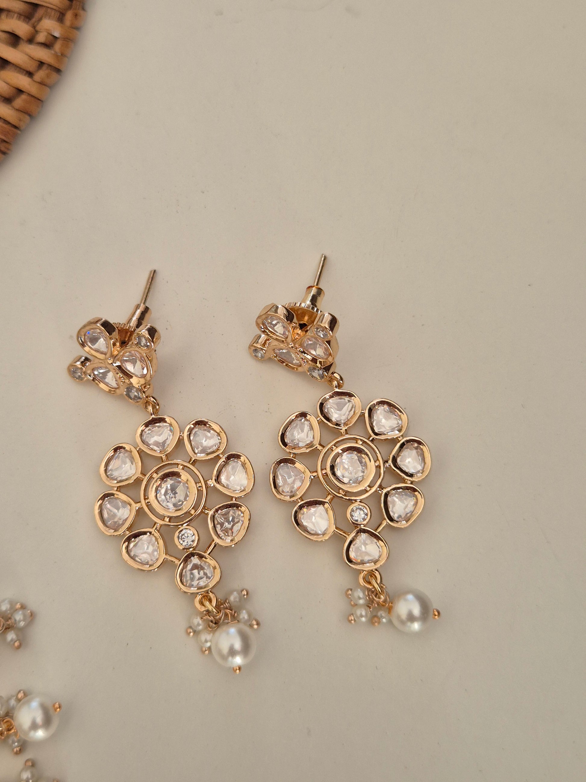 A timeless handcrafted alloy necklace set for a modern Indian Pearl and American Diamond Gold-Toned Necklace Set aesthetic earrings by naitri.in
