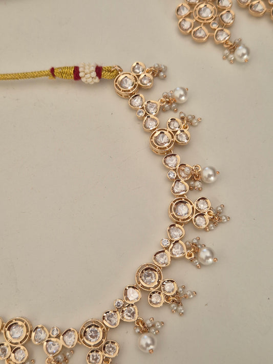 Handcrafted Indian bridal jewelry set featuring a delicate American diamond choker necklace and matching dangle earrings by naitri.in