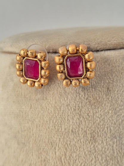 Ornate gold-toned fashion jewelry set with a detailed pendant design and matching earrings for ethnic wear by Naitri.in