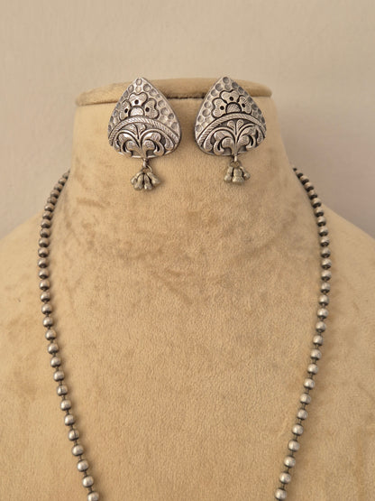 oxidized silver teardrop earrings intricately carved geometric earrings featuring dangling bead charms, by naitri.in