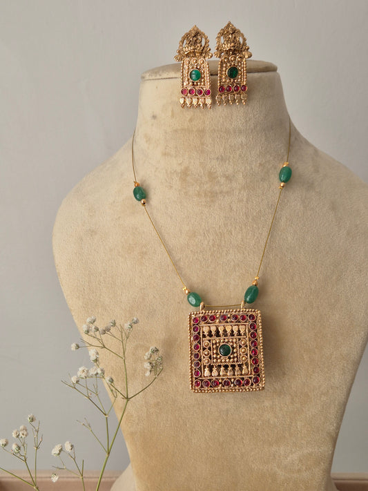 Reversible Anjna necklace set featuring a square gold-plated pendant with red and green stones on a thin invisible chain, includes matching jhumka-style earrings by naitri.in