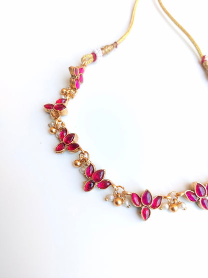 Antique gold-plated Reversible Lotus Temple Jewellery Necklace Set with red and green stones.
