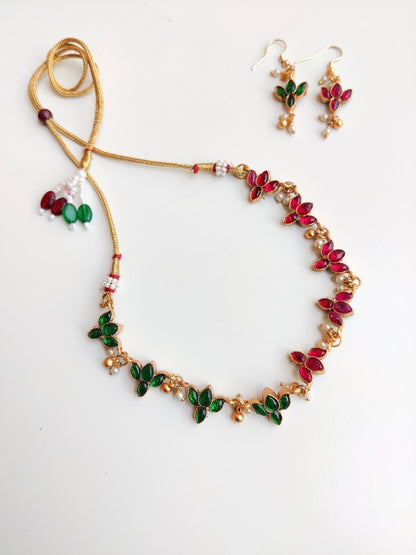 Antique gold-plated Reversible Lotus Temple Jewellery Necklace Set with red and green stones.
