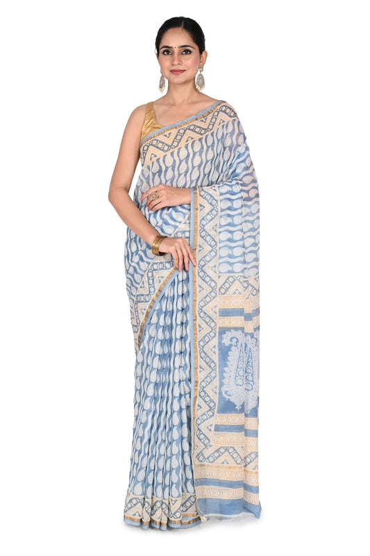 Woman modeling the Rini Maheshwari Saree, a beige and blue hand block printed cotton silk saree with intricate geometric patterns and a gold-toned border by naitri.in