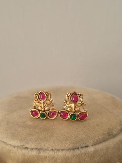 Handcrafted gold earrings with red and green stones by naitri.in