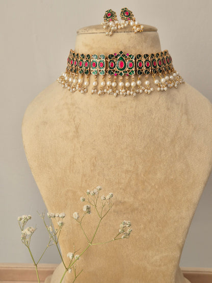 Choker Set with emerald green and ruby pink stones, gold-toned finish, and white pearl droplets by Naitri.in
