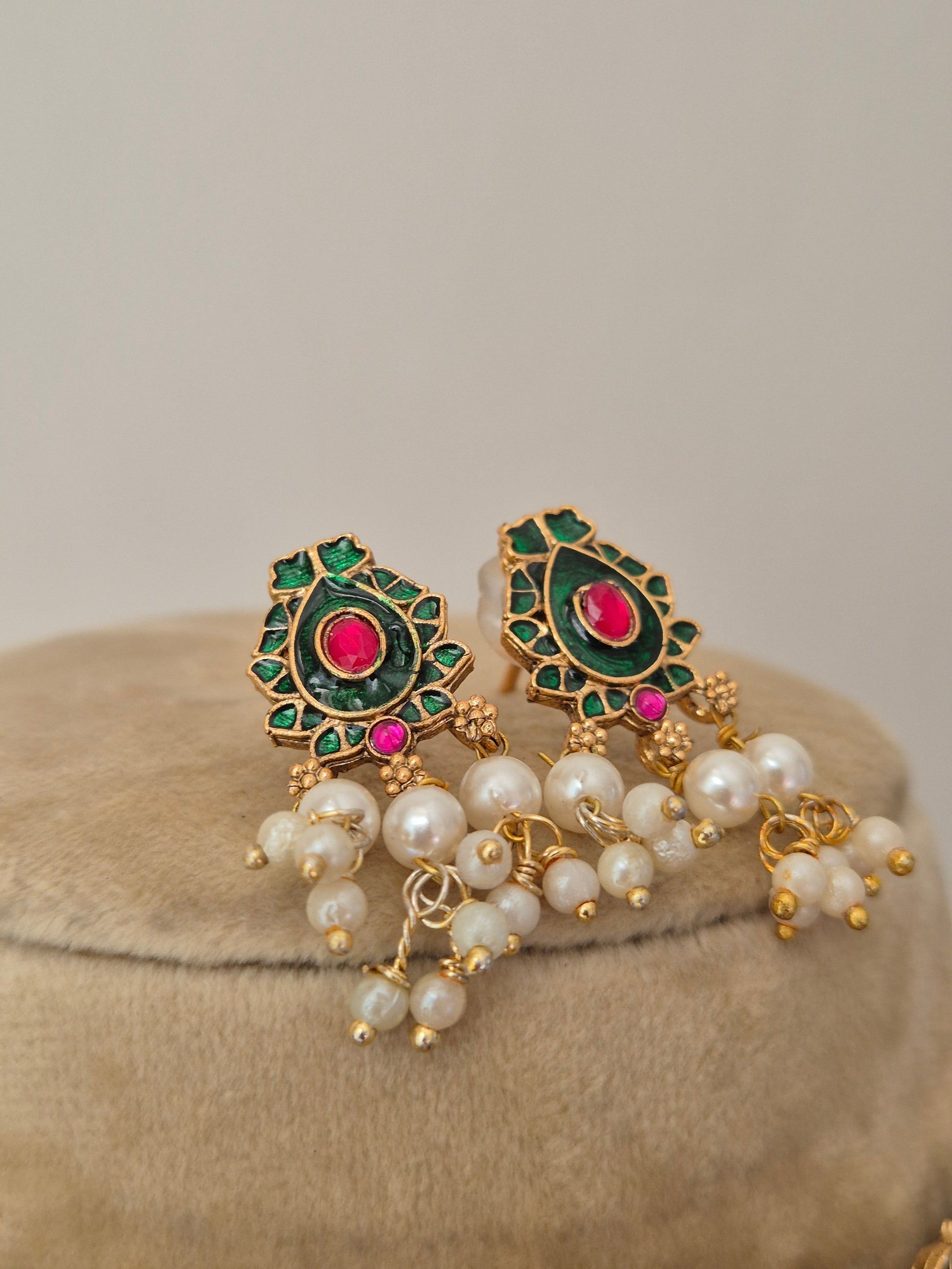 gold-toned earring set with pink and green stones and pearl hangings by naitri.in
