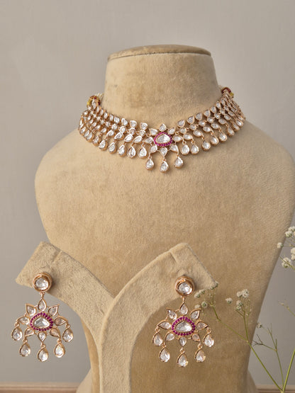 Handcrafted choker featuring sparkling white American Diamonds and central ruby-red stone accents with teardrop drops by naitri.in