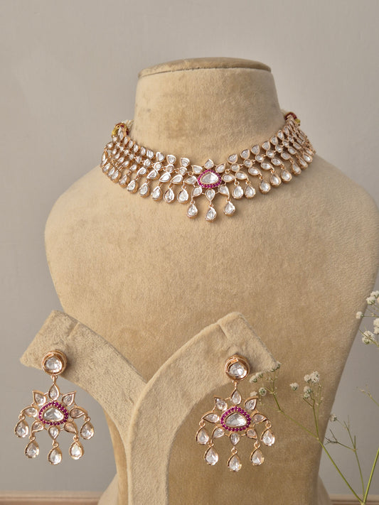 Handcrafted choker featuring sparkling white American Diamonds and central ruby-red stone accents with teardrop drops by naitri.in