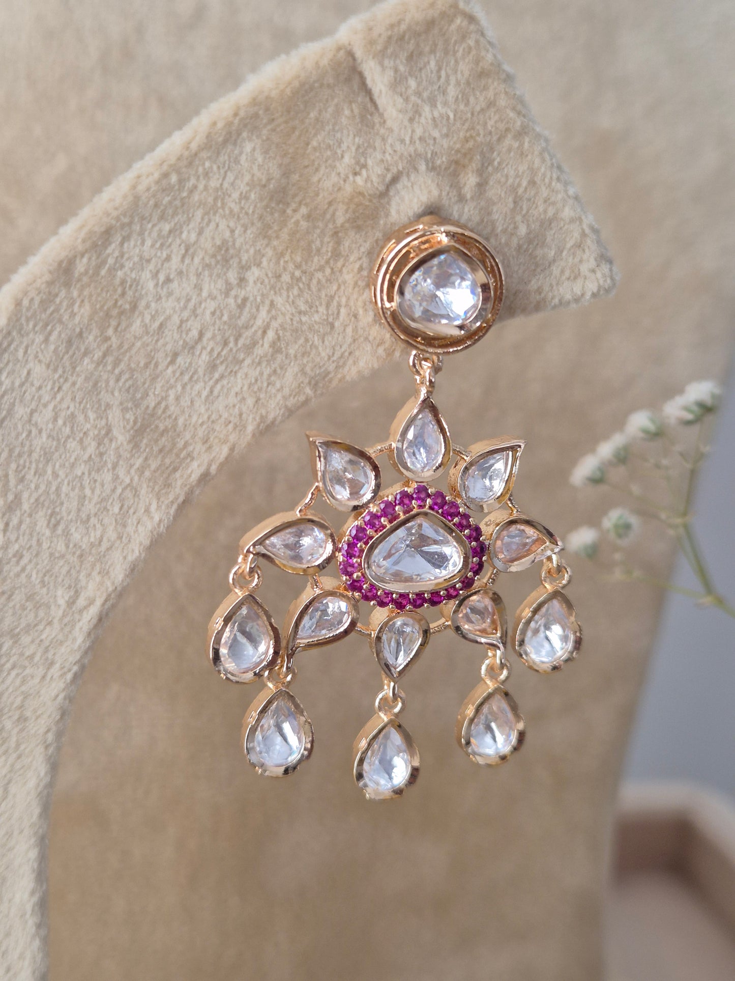 "Pair of matching Rosalie American Diamond drop earrings with ruby-red centers and teardrop accents by naitri.in 